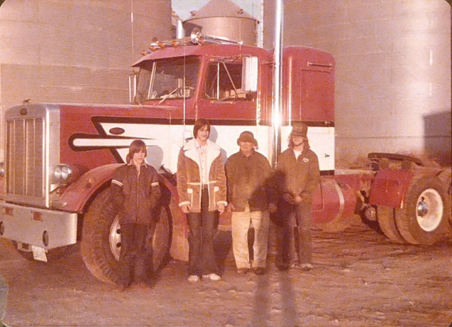 Lubianski family beside a company feed truck